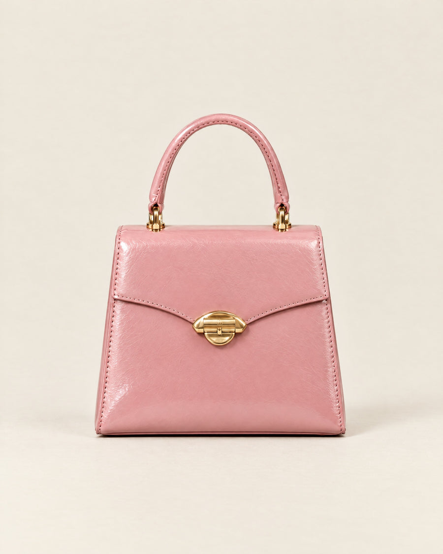 La Promenade Mini in peony-pink glazed calf with a gold arch clasp