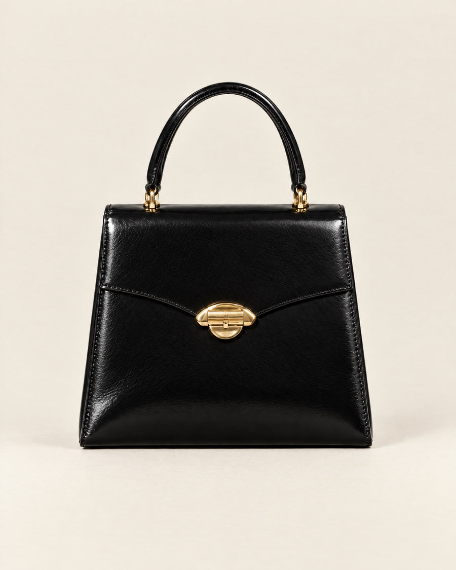 Le Cavalier top-handle bag in black glazed calf with a gold arch clasp