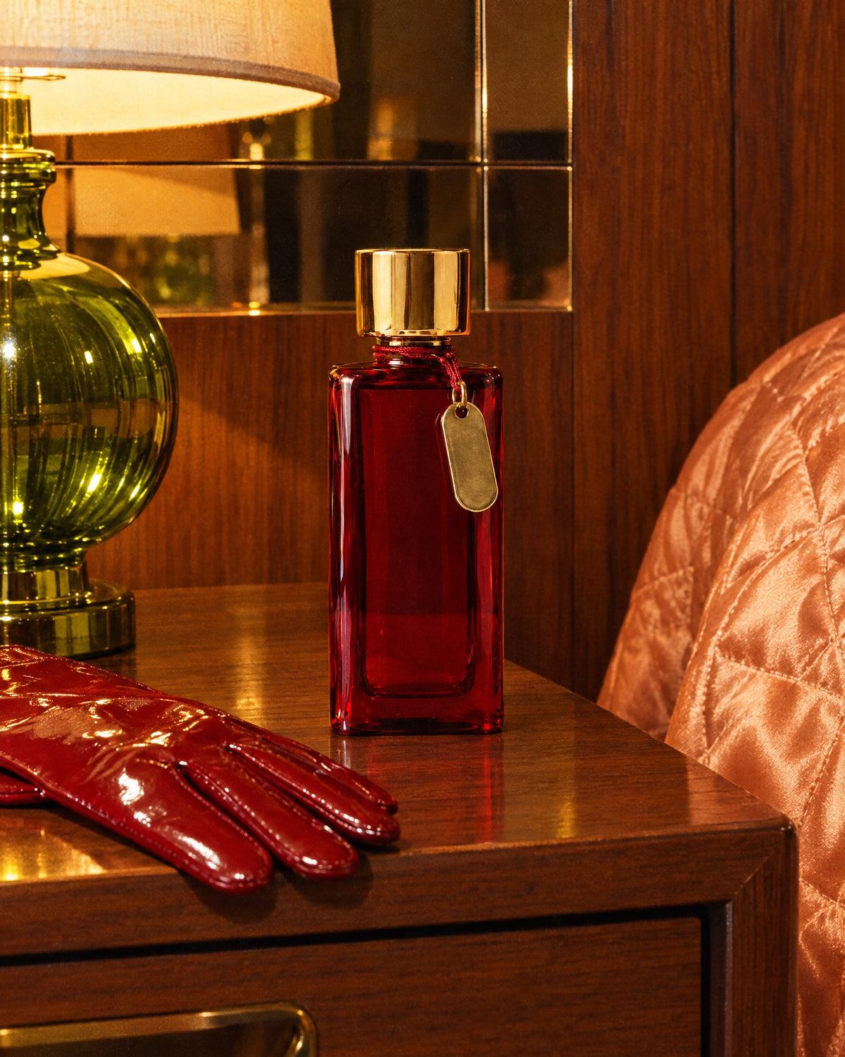 Chambre 12 on a walnut bedside table in a 70s hotel room beside a red patent glove