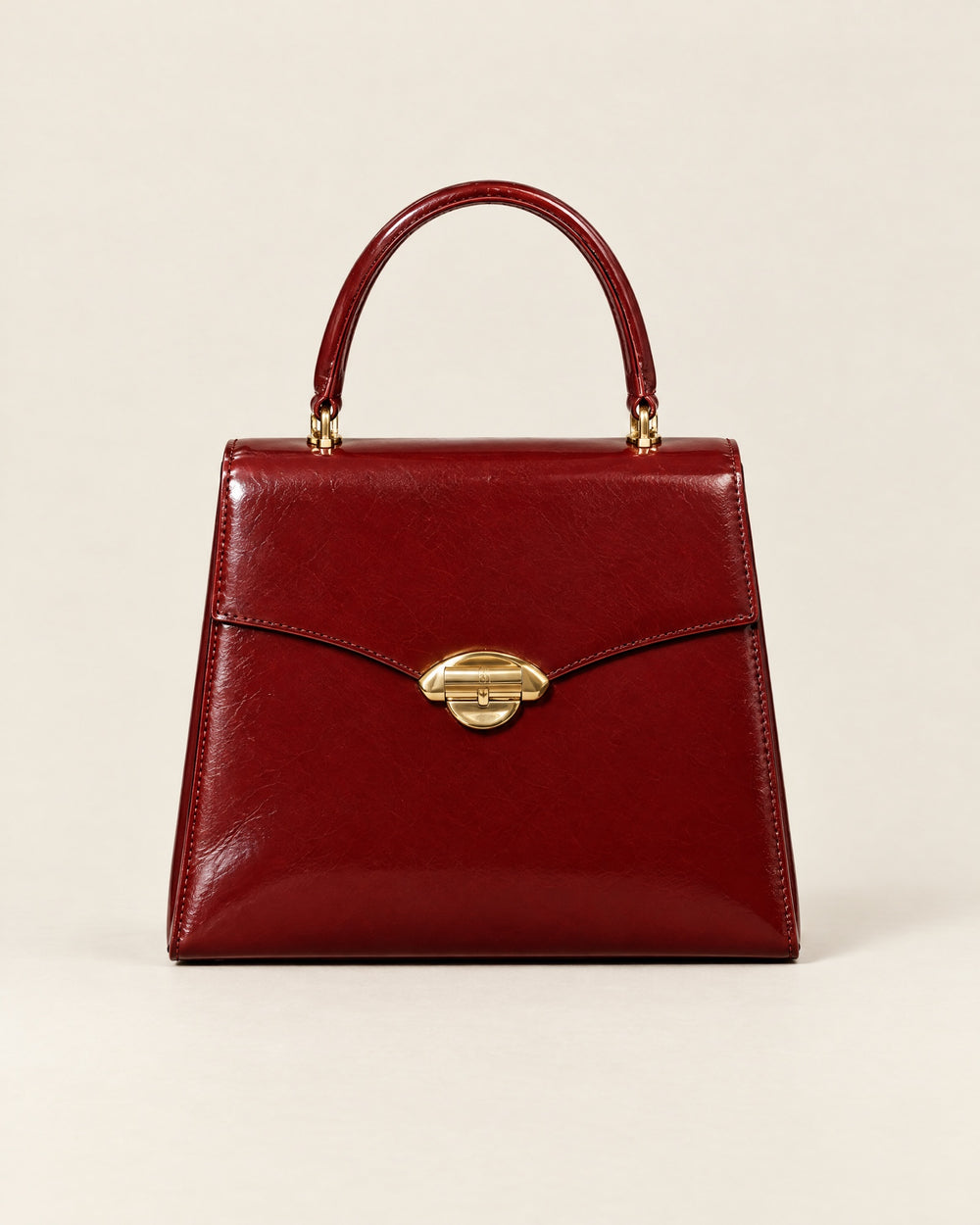 La Promenade top-handle bag in lacquer-red glazed calf, front view