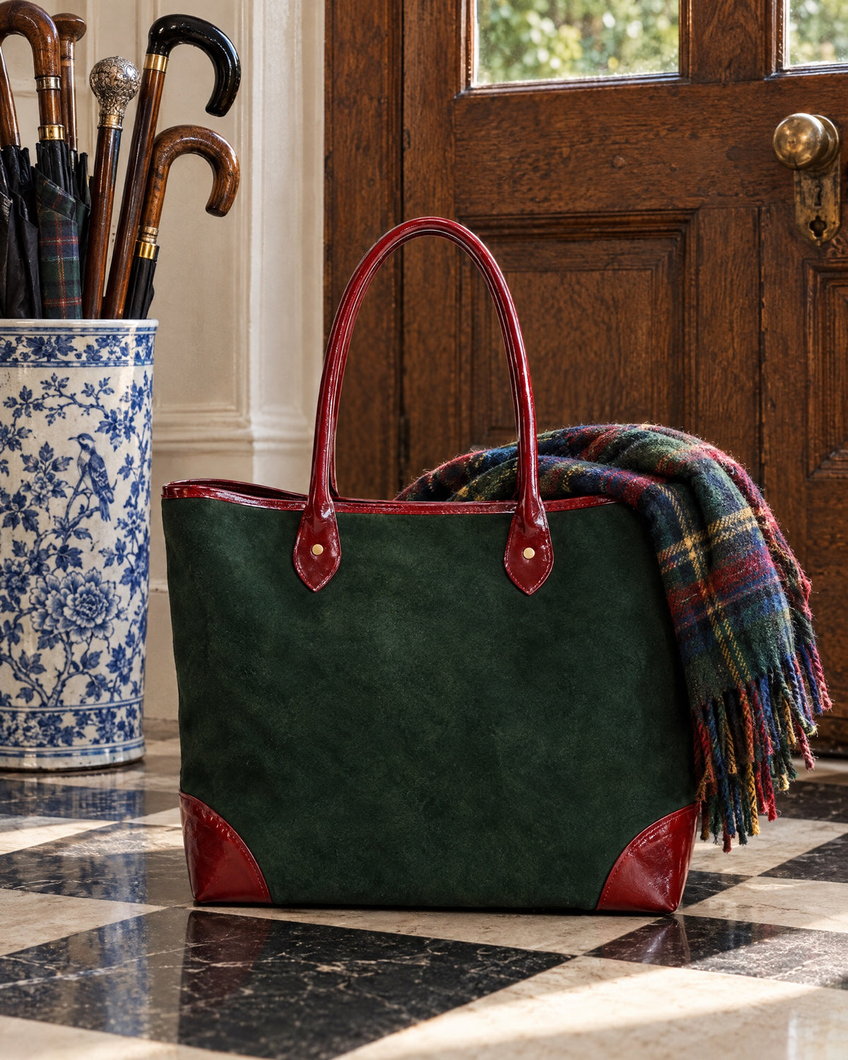 Le Cabas on a checkerboard marble floor by a doorway with walking canes in a stand
