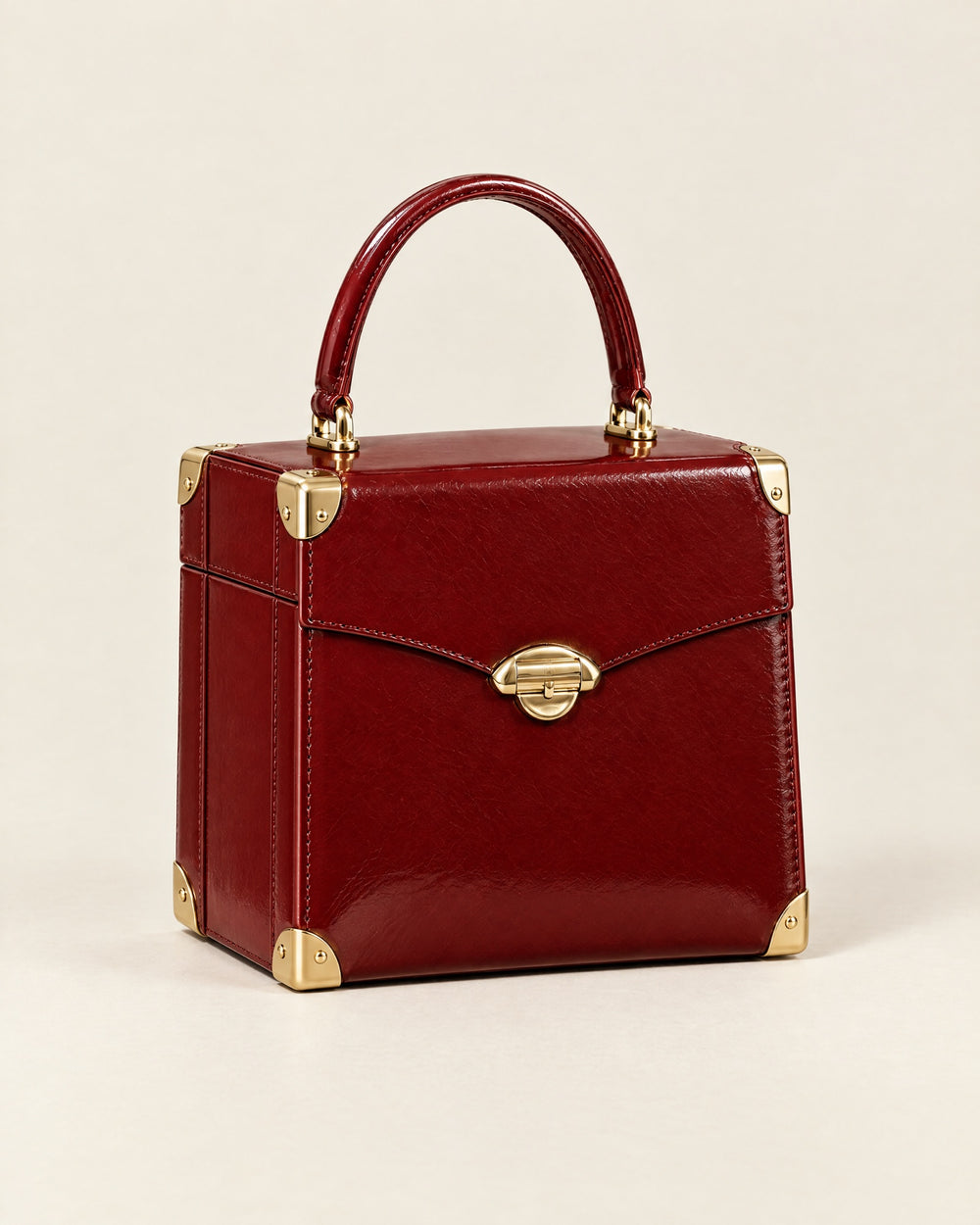 Le Vanity trunk-style case in lacquer-red glazed calf with gold corners and a gold arch clasp