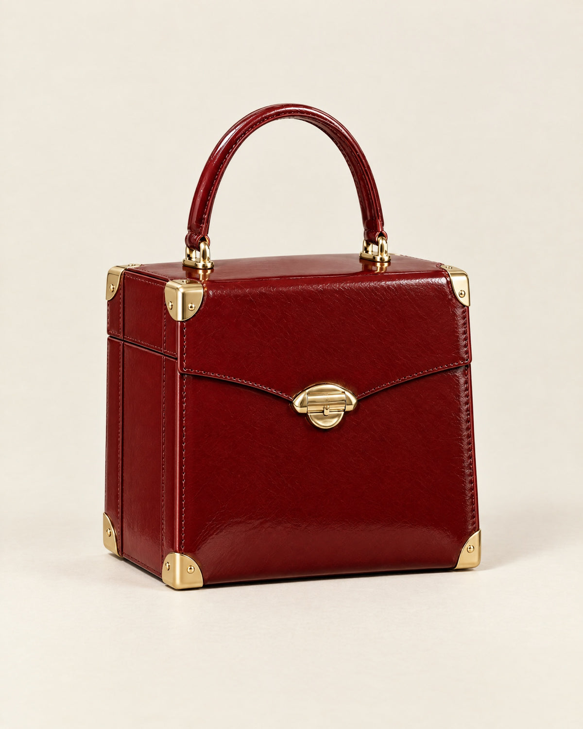 Le Vanity trunk-style case in lacquer-red glazed calf with gold corners and a gold arch clasp