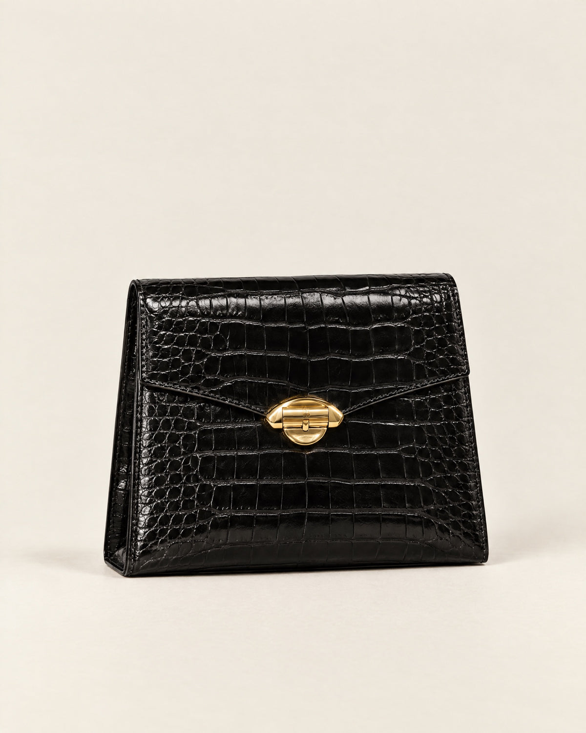 Pochette Minuit evening clutch in black croc-embossed leather with a gold arch clasp