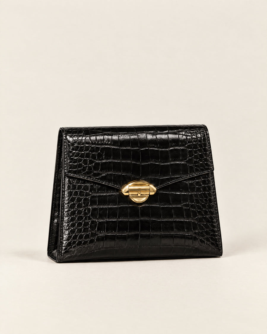 Pochette Minuit evening clutch in black croc-embossed leather with a gold arch clasp