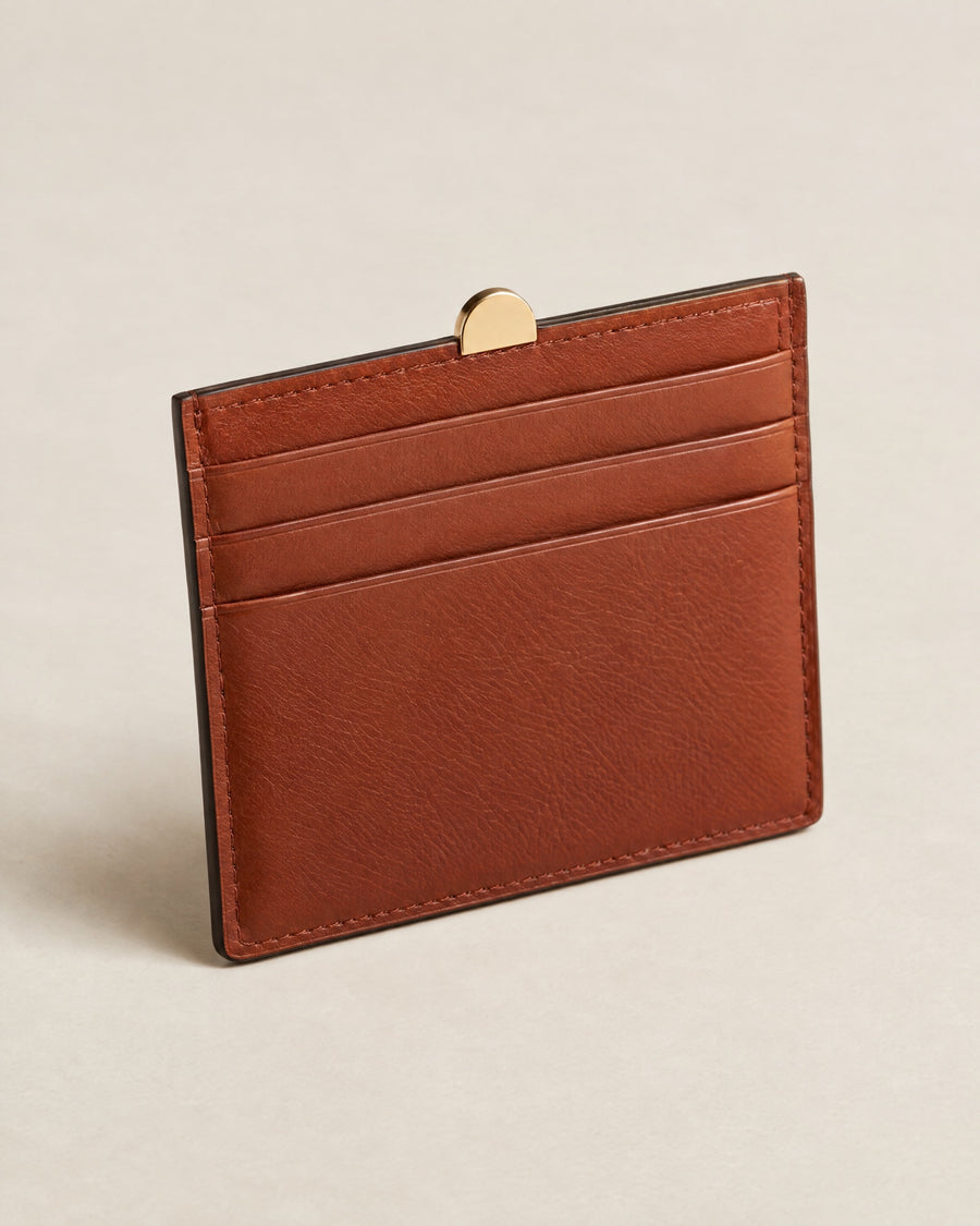 Porte-Cartes Brique card holder in brick-rust calf with a gold arch tab