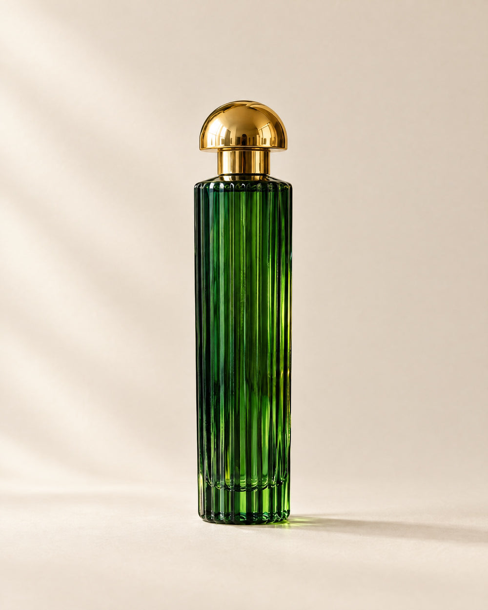 Tournesol eau de parfum, a tall fluted green glass flacon with a gold dome cap